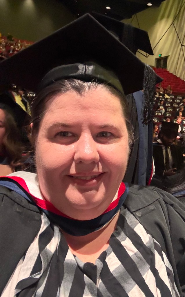 Krista in her Graduate cap and gown at Graduation